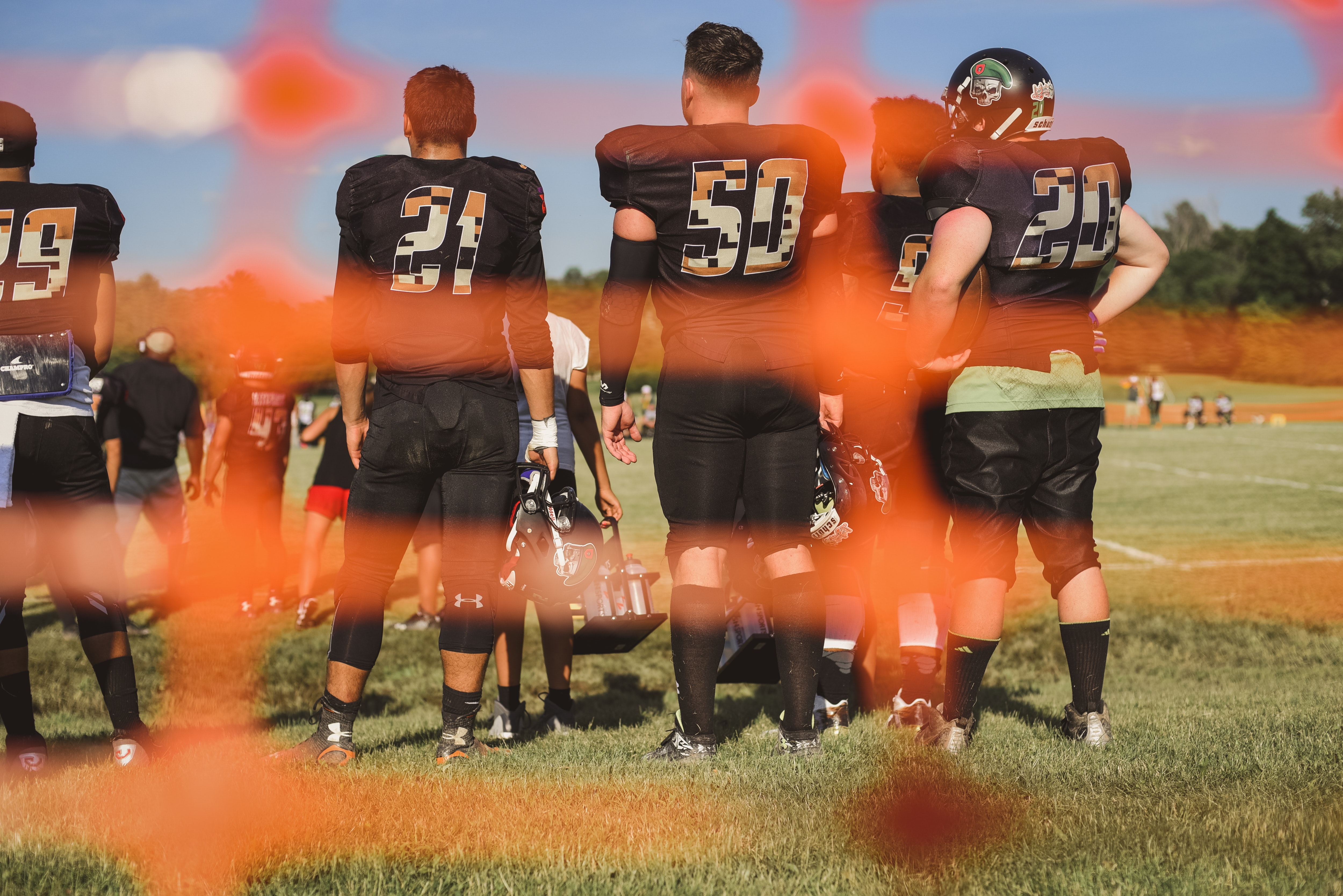 selective-focus-photography-of-football-team-on-field-2253881